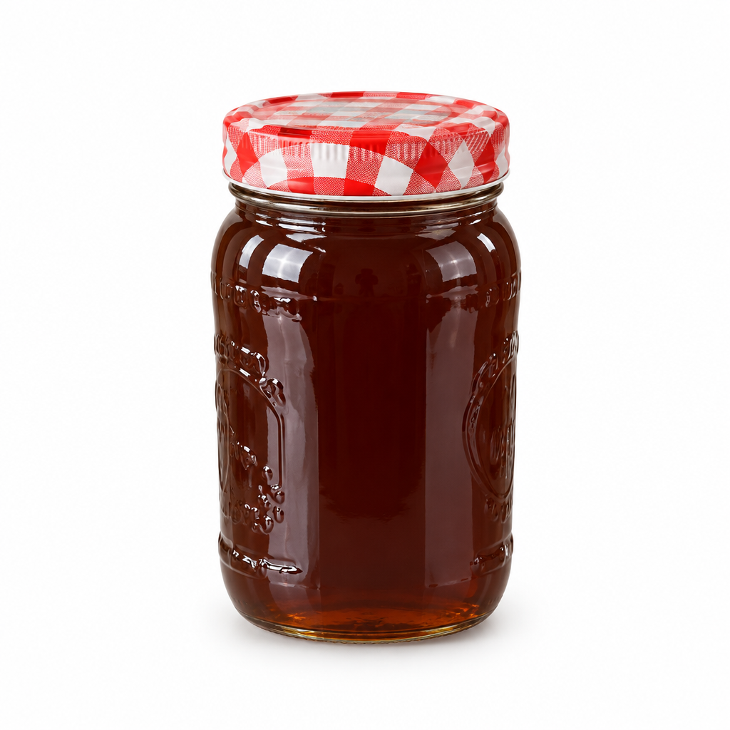 Single glass honey jar on a white studio background